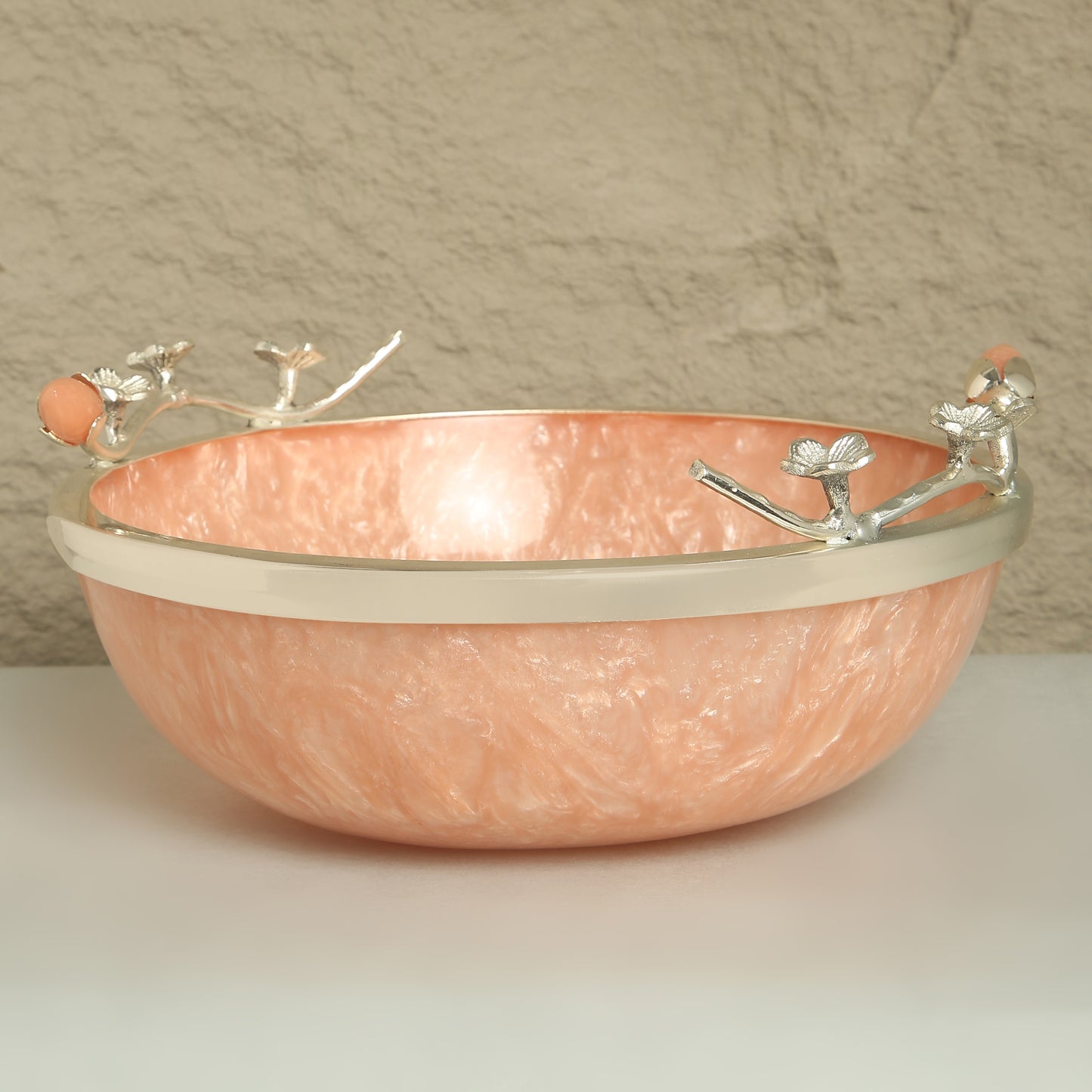 Copper bowl with silver decorative elements on a neutral background