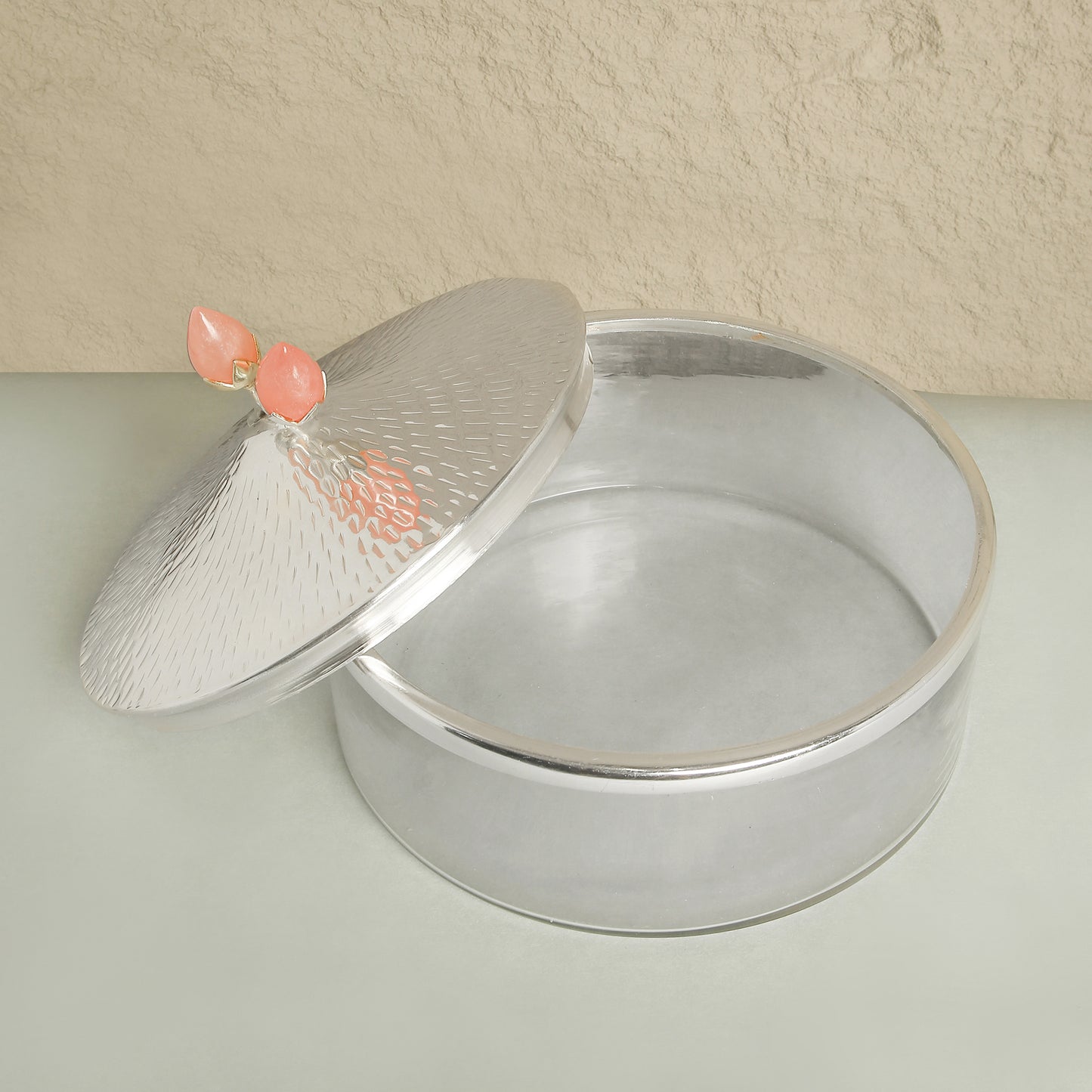 Silver cake pan with a lid on a light surface