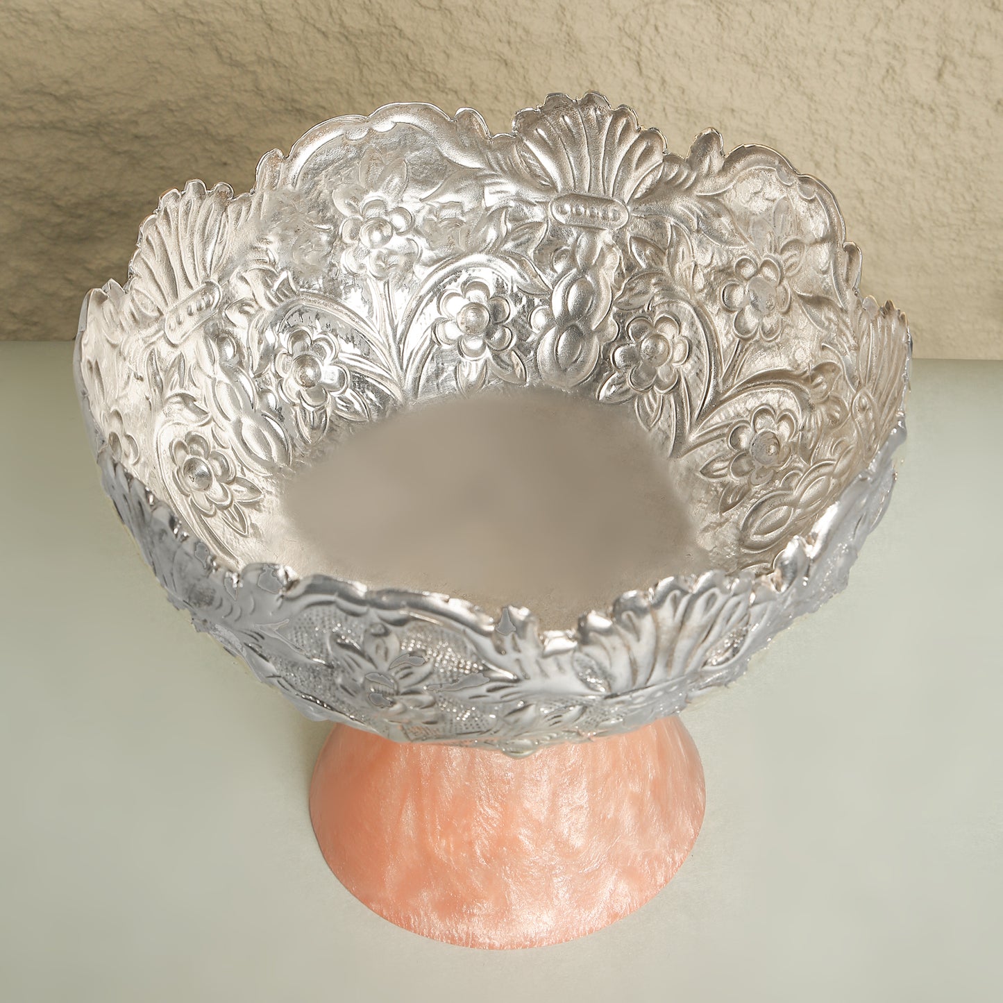 Decorative glass bowl with floral patterns on a plain background