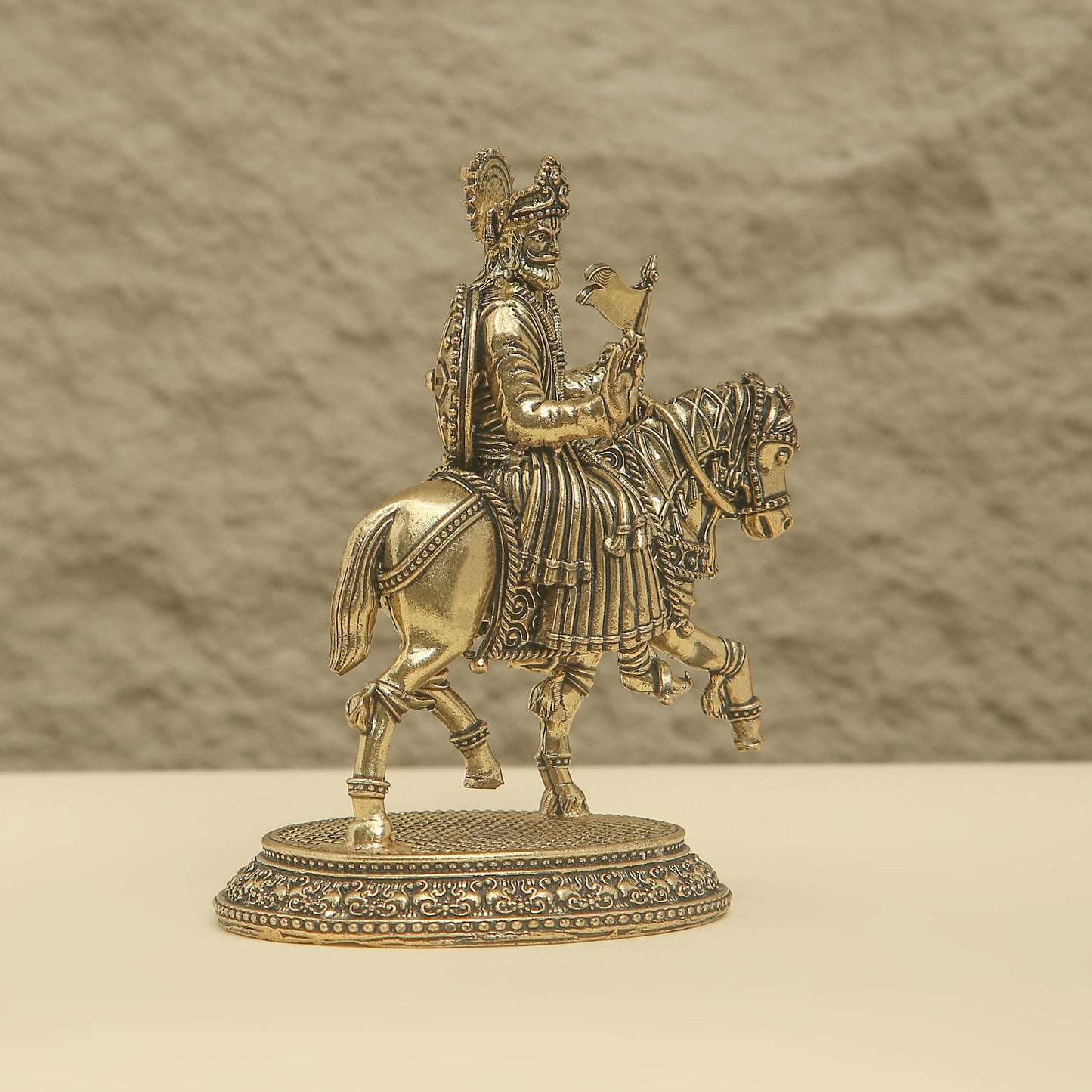 Bronze statue of a warrior on horseback with a blurred background
