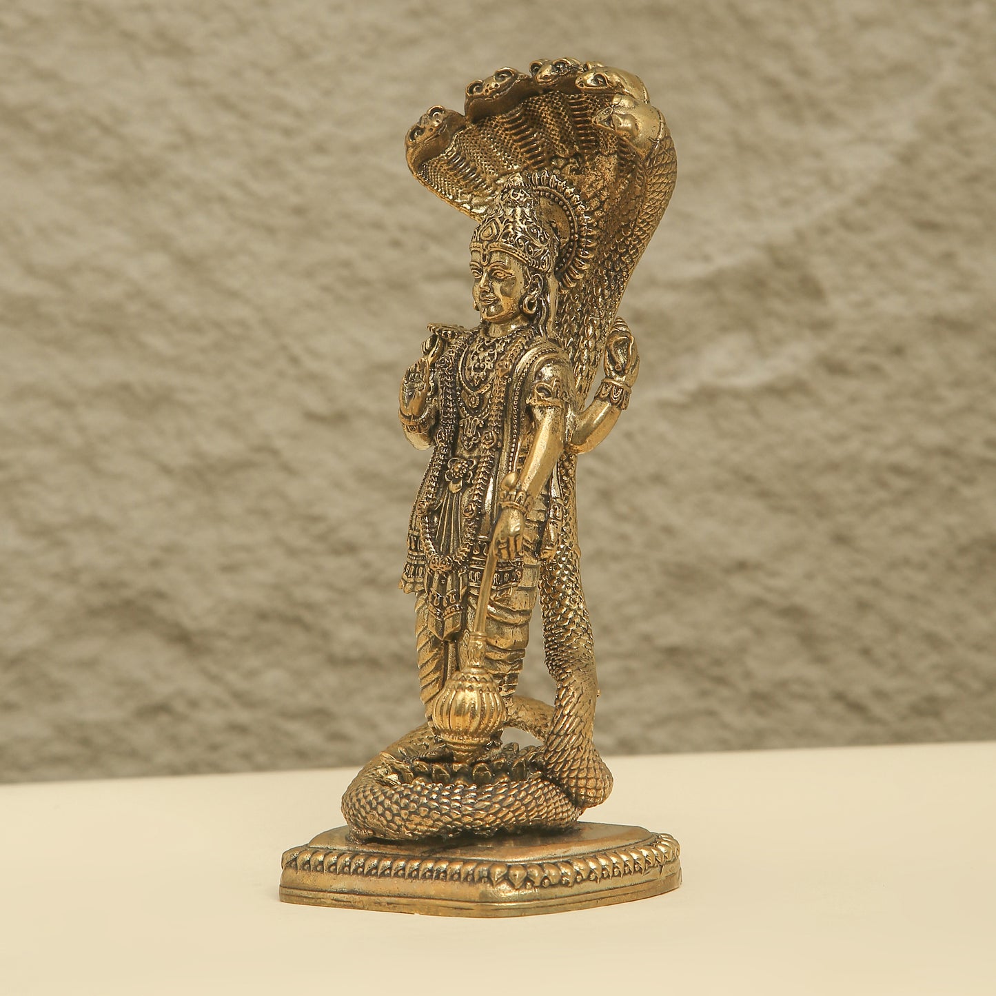 Decorative statue of a figure with intricate details on a textured surface
