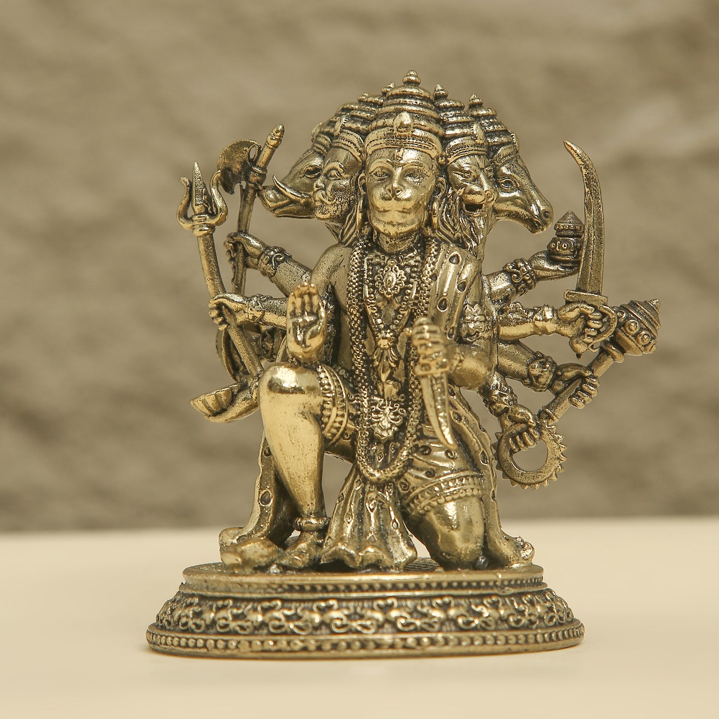 Bronze statue of a multi-armed deity with a blurred background