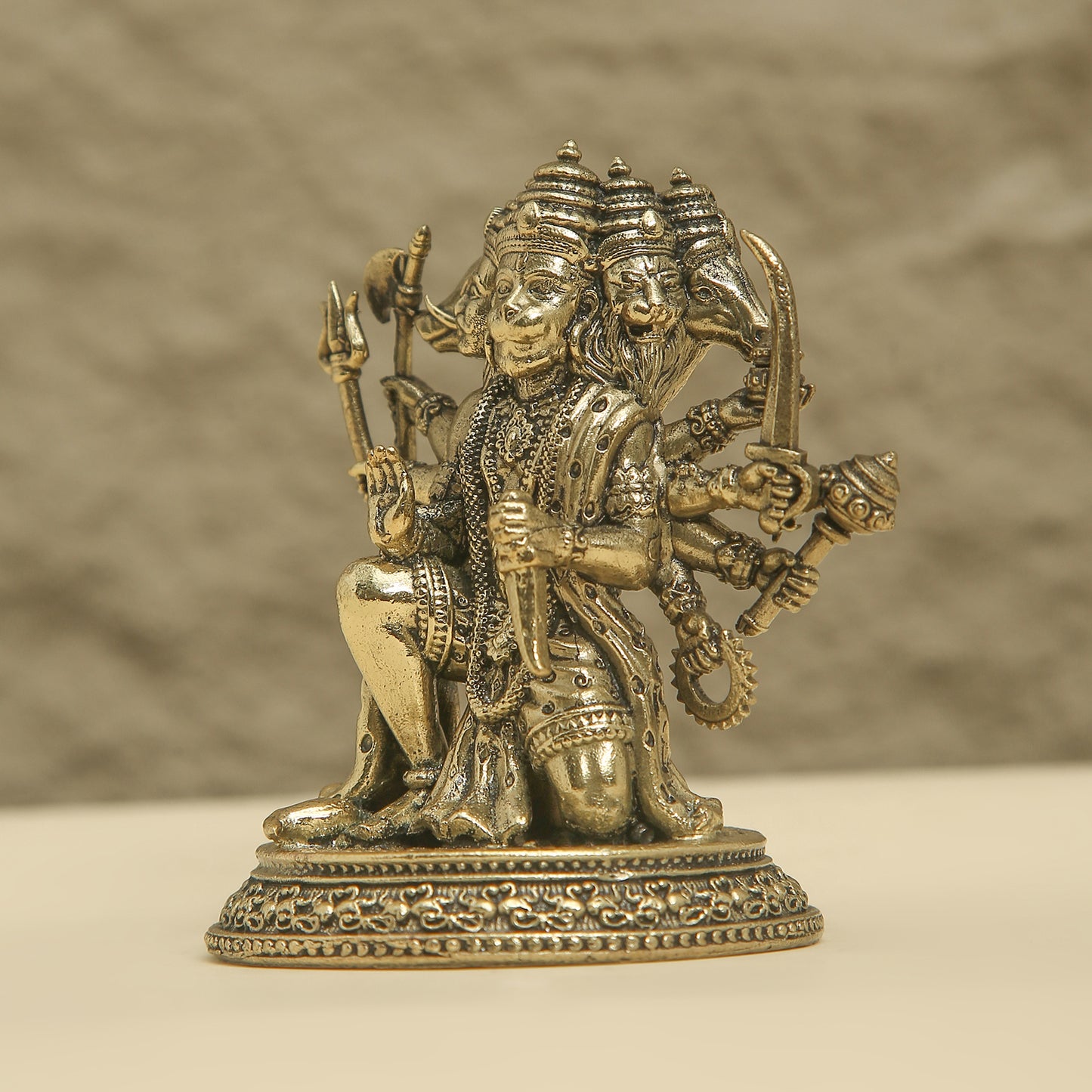 Bronze statue of a multi-armed deity with a blurred background