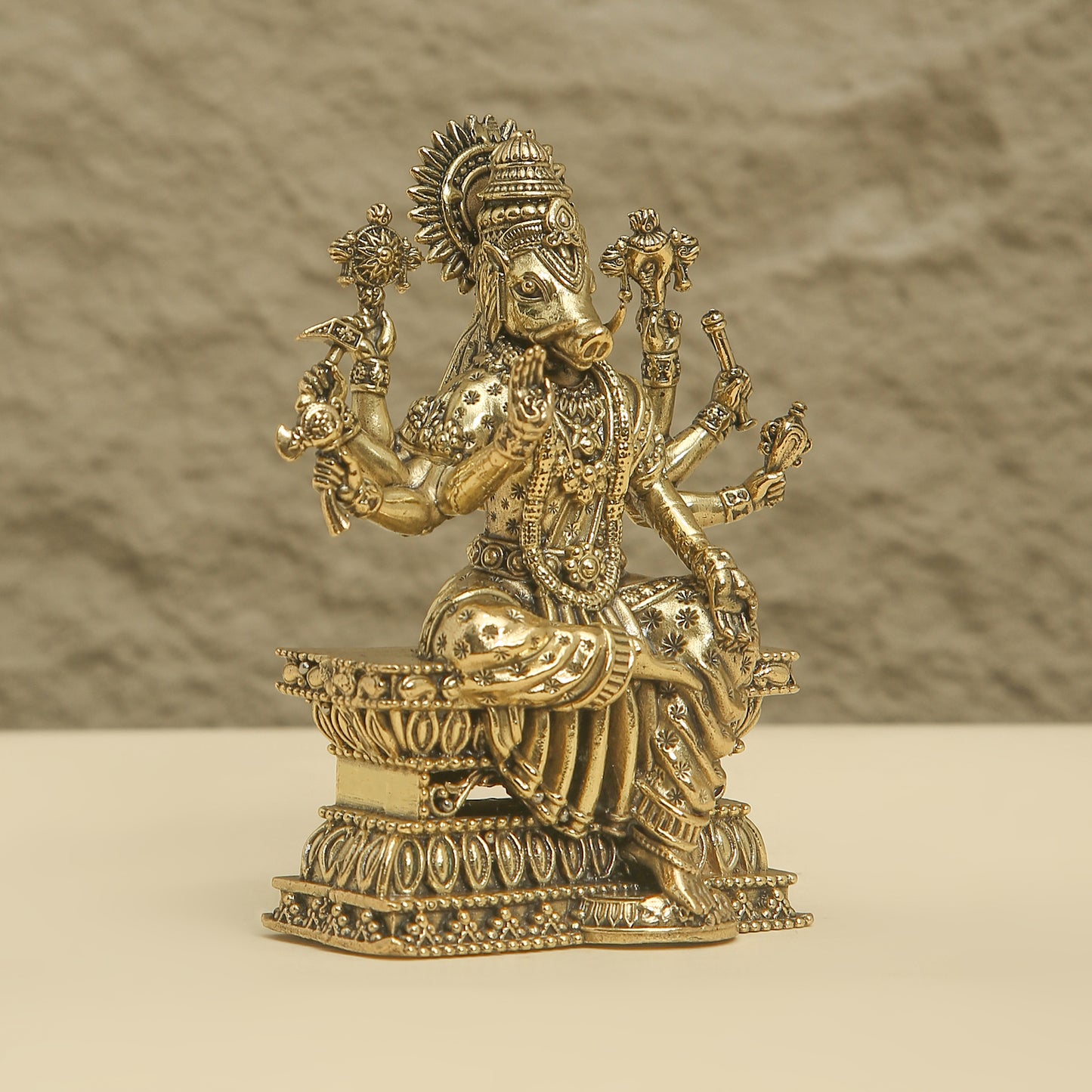 Decorative gold statue on a beige background