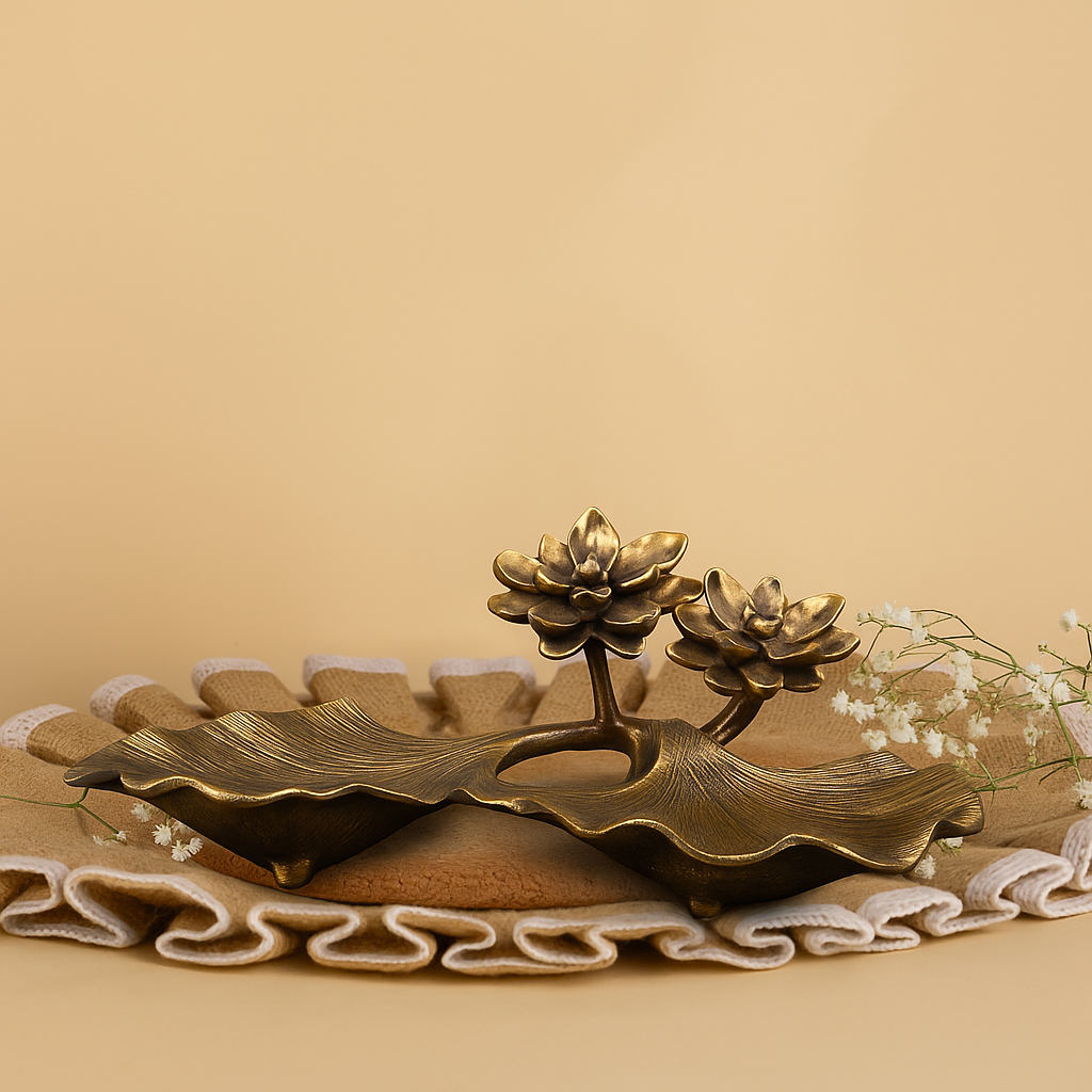 Bronze lotus flower sculpture on a textured surface with a beige background