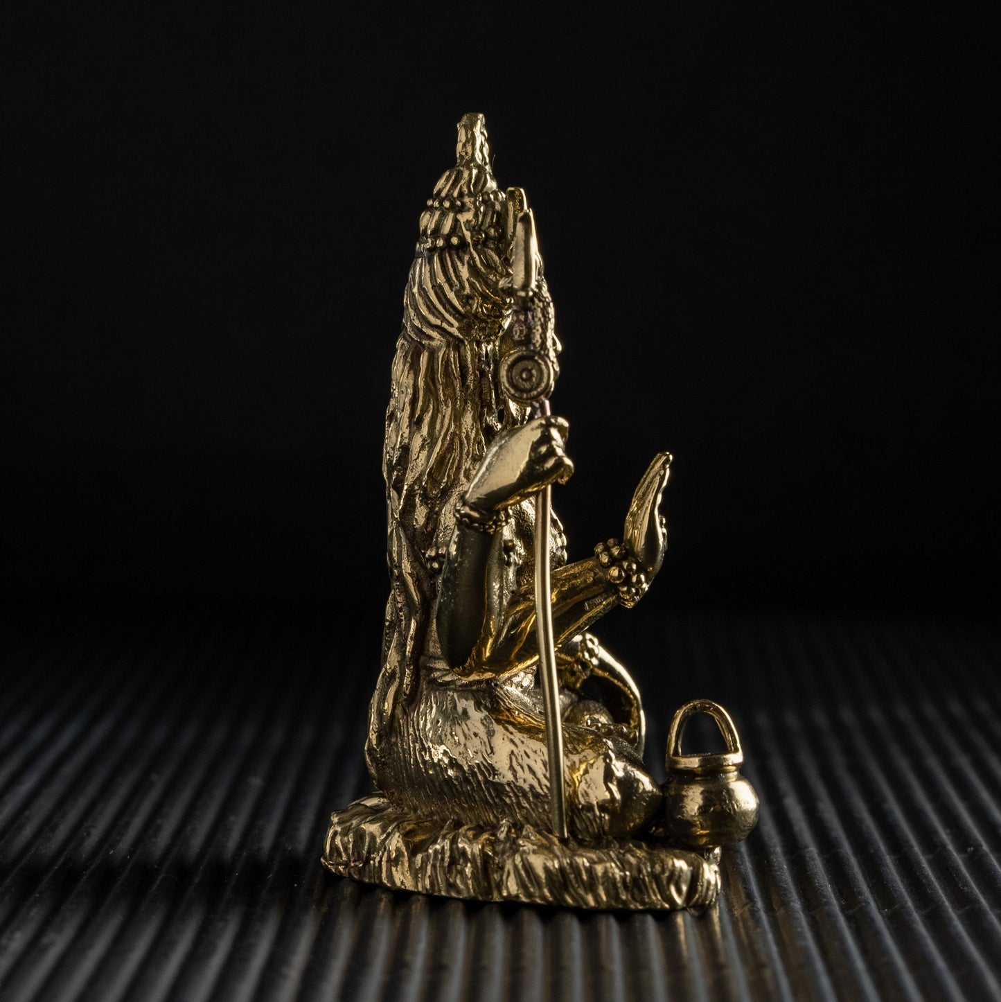 Gold statue on a textured black surface