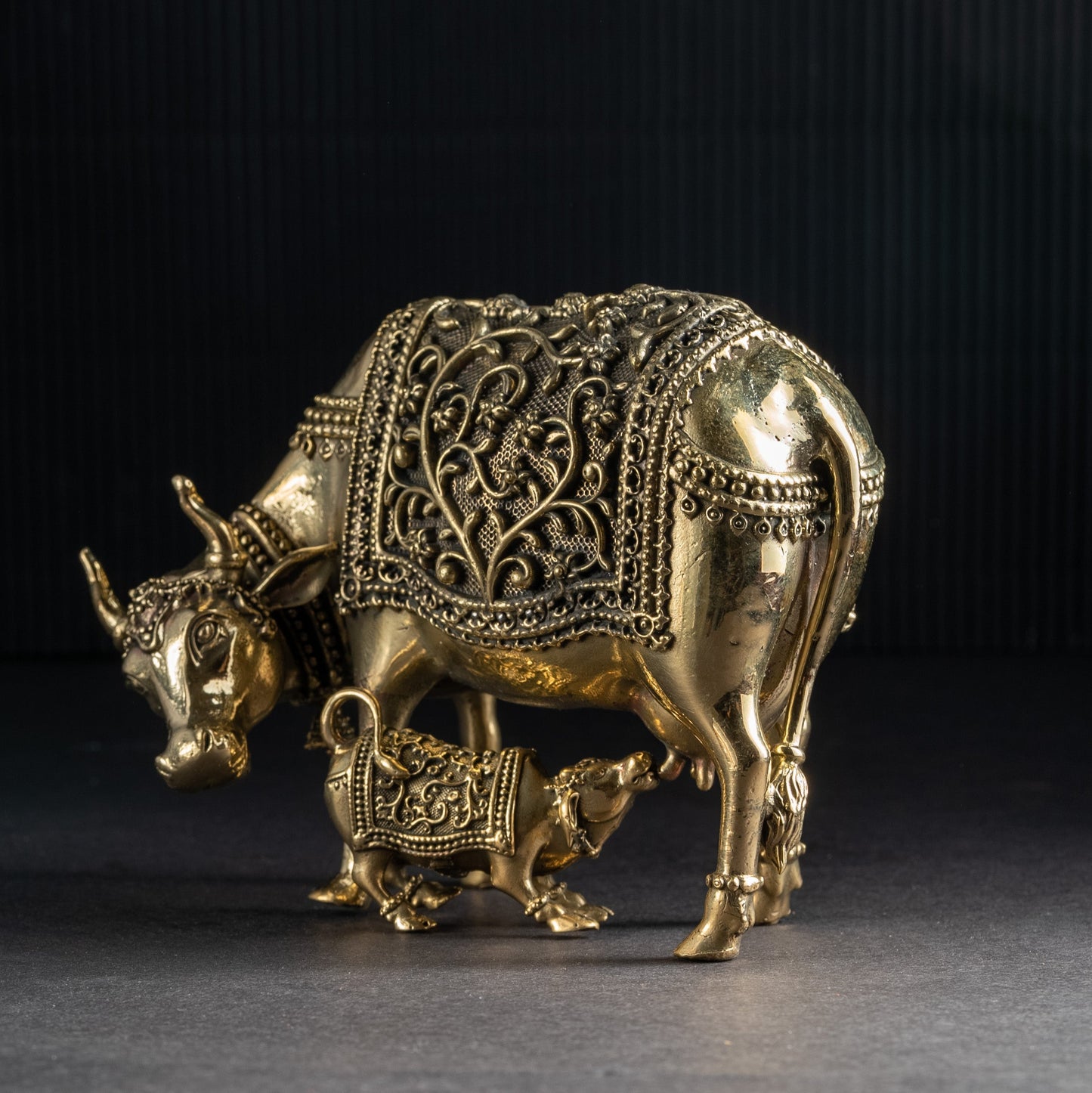 Decorative brass bull figurine on a dark background