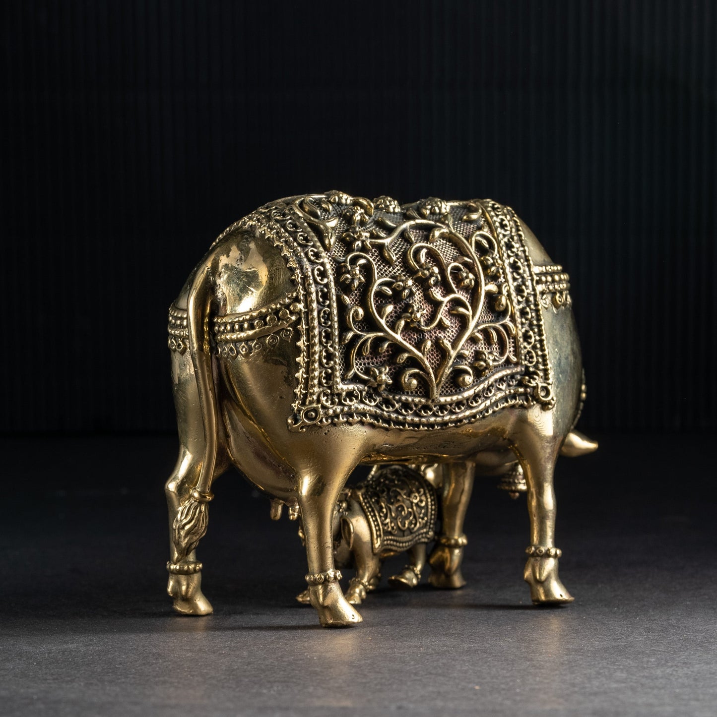 Decorative brass elephant on a dark background