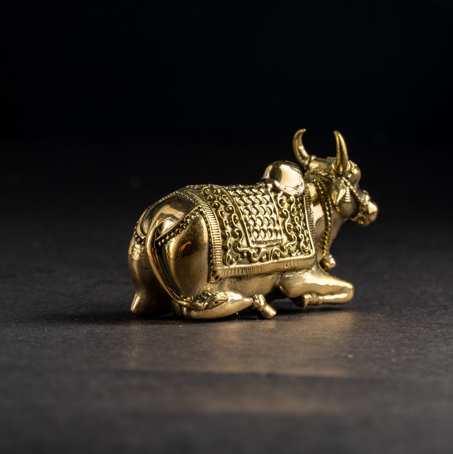 Gold bull figurine on a black background