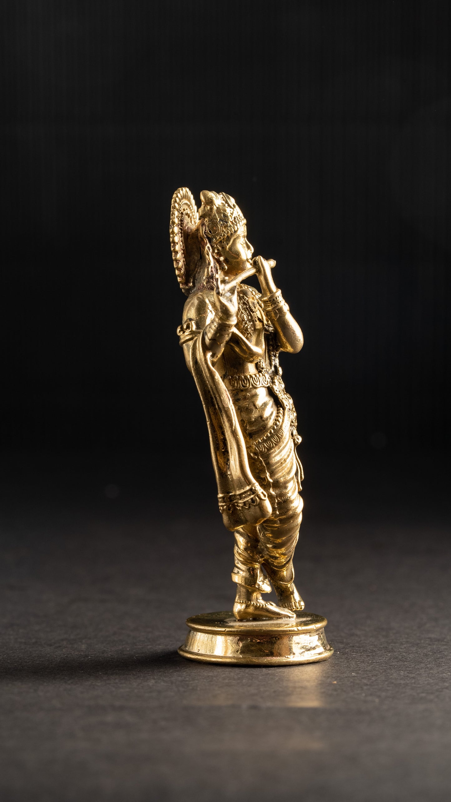 Gold figurine of a warrior on a dark background