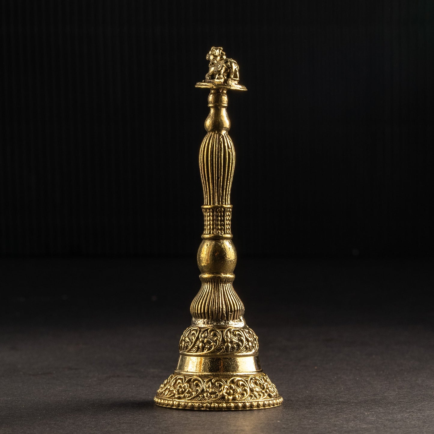 Bronze or brass object with a lion emblem on a dark background