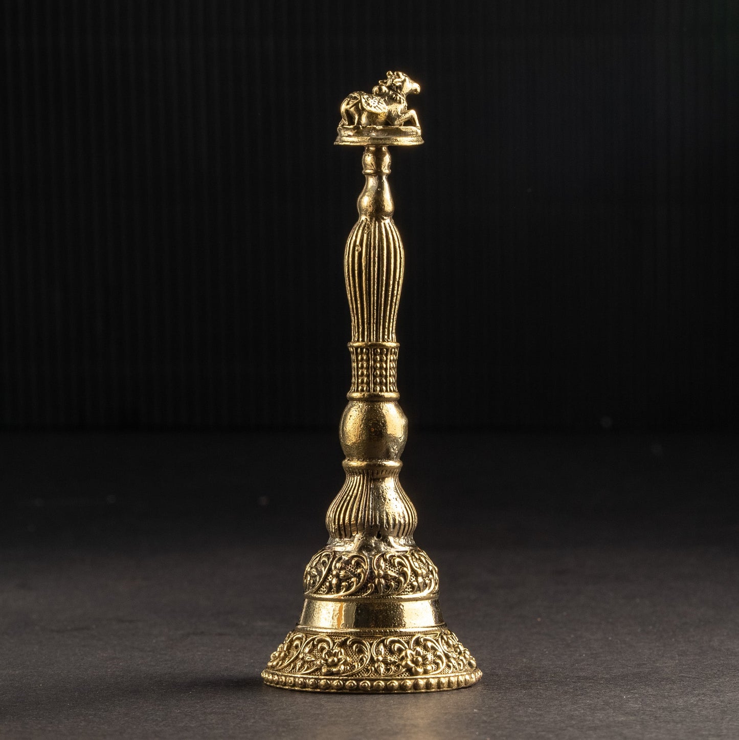 Gold-colored decorative object on a black background