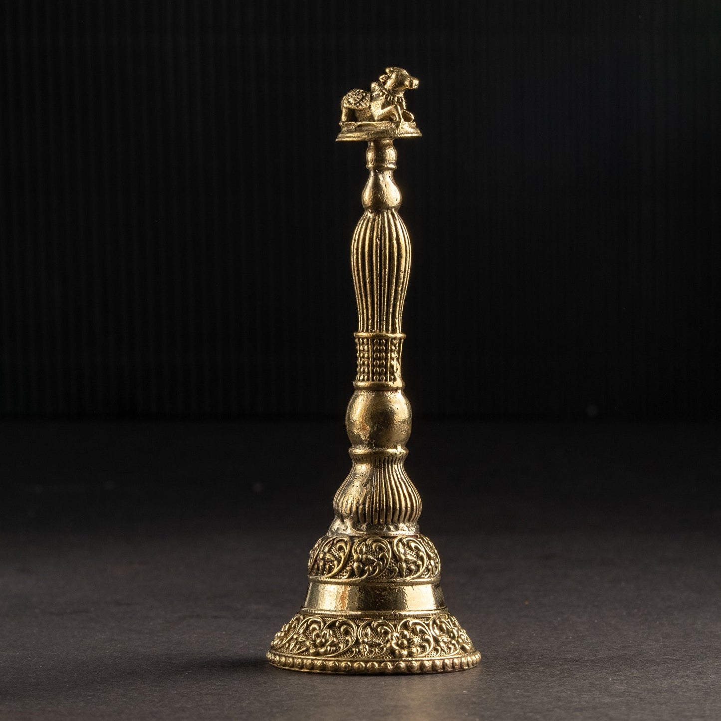 Gold-colored decorative object on a black background