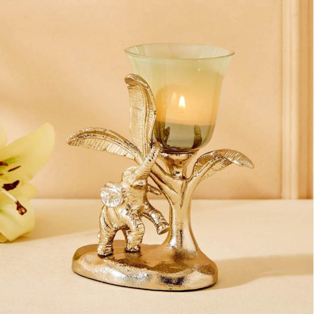 Decorative candle holder with elephant and leaf design on a beige background