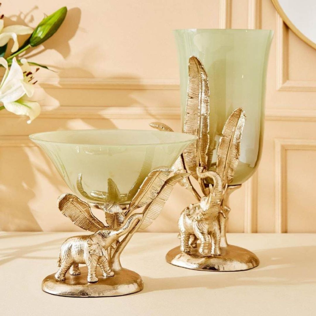 Decorative glass bowl with elephant and leaf design on a beige surface.