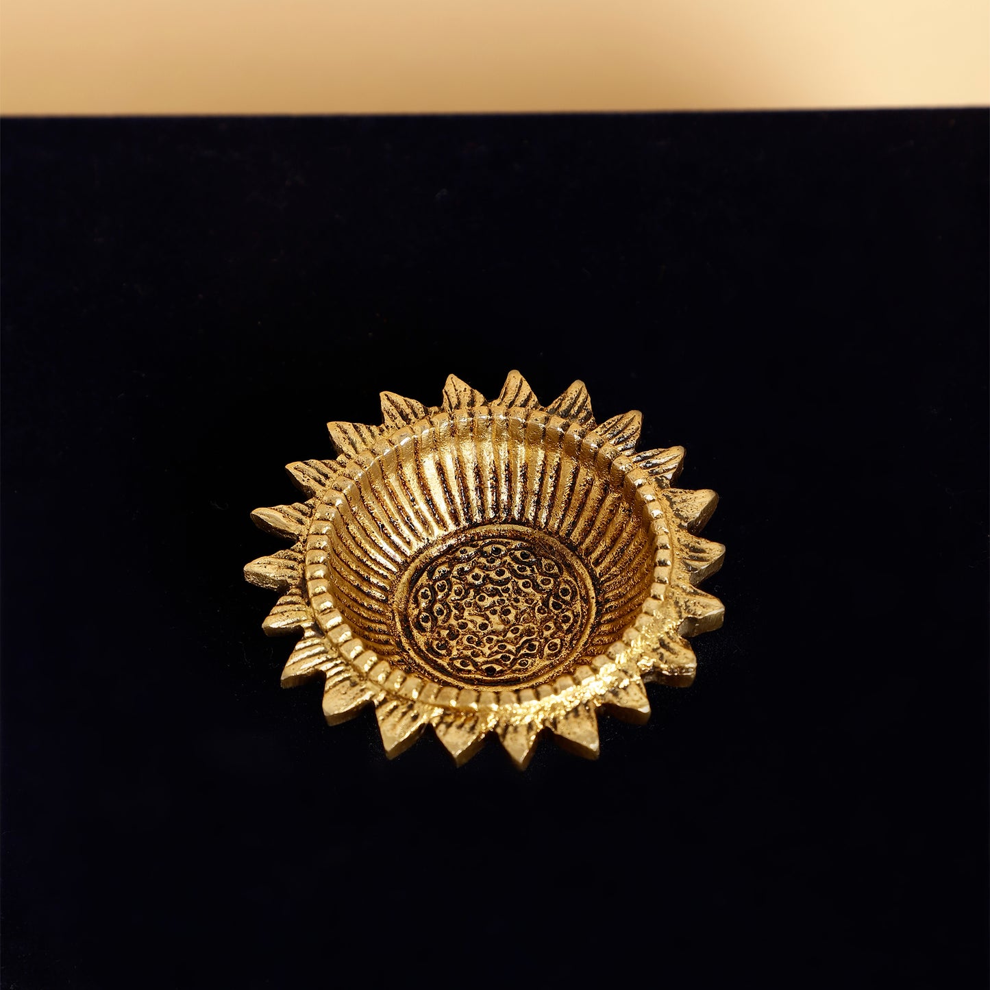Gold decorative item on a black background