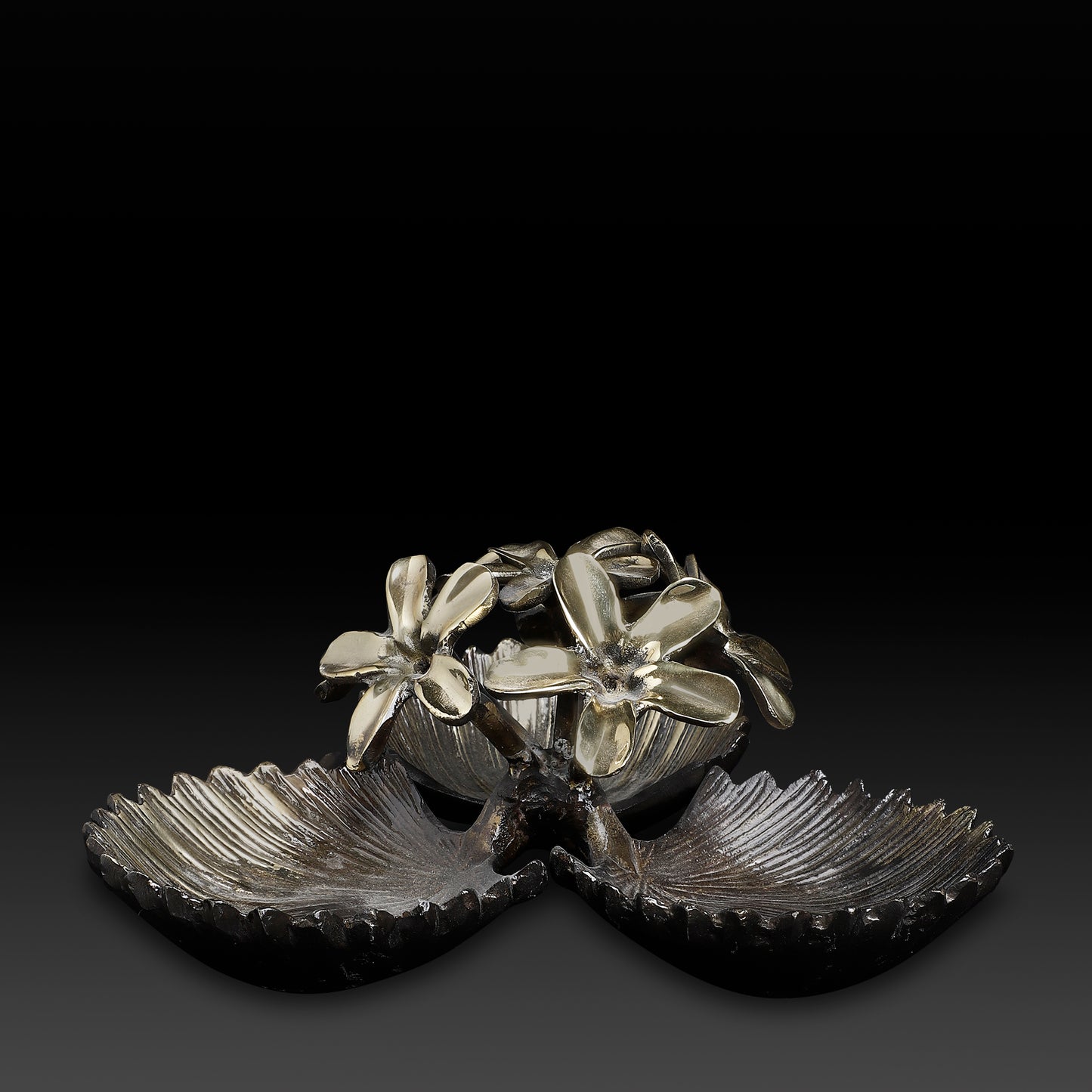 Decorative metal piece with floral design on a black background