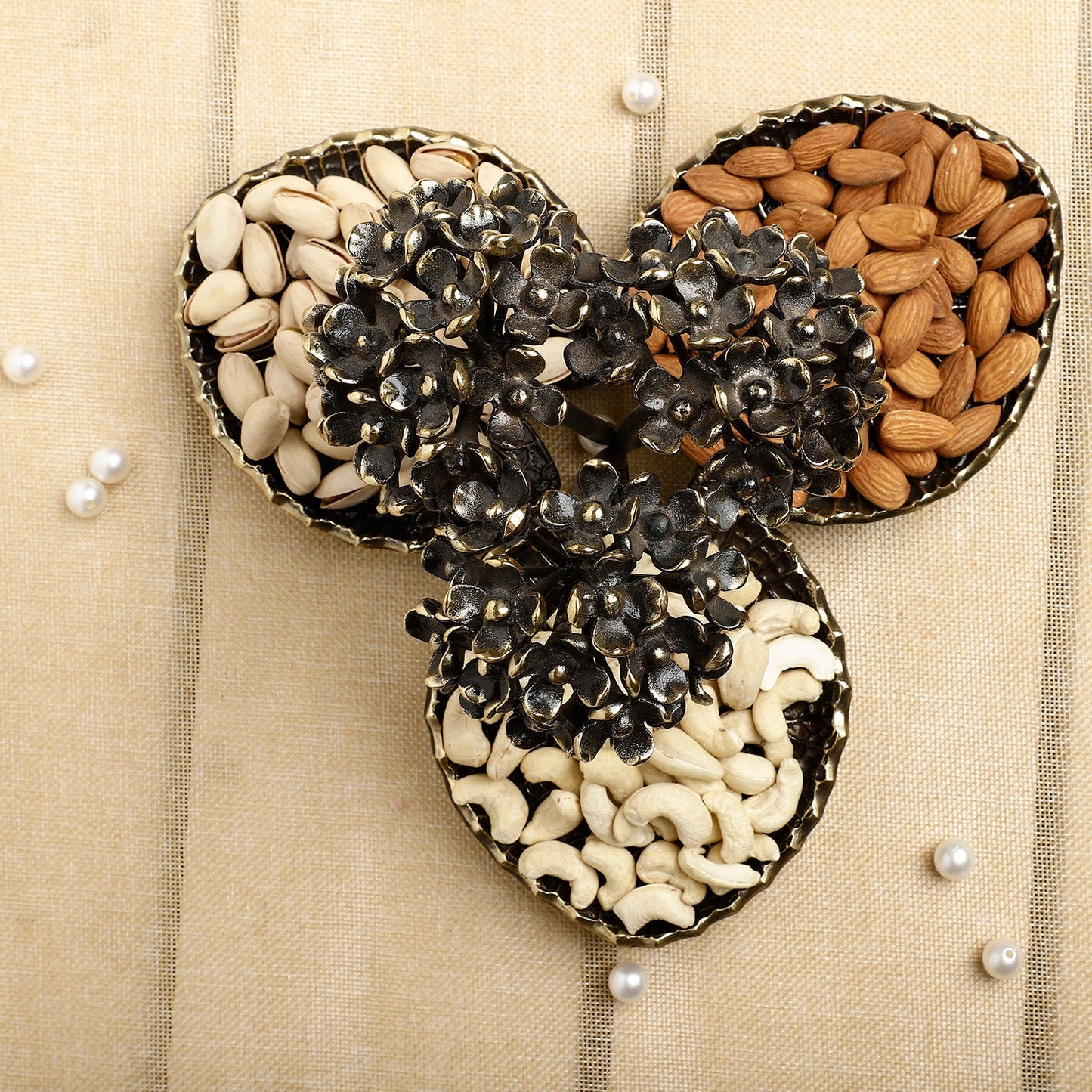 Decorative item shaped like a bow with seeds on a beige background