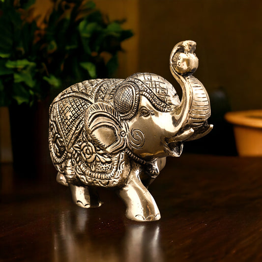 Decorative elephant figurine with intricate patterns on a wooden surface
