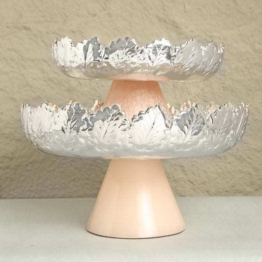 Two-tiered decorative bowl with cut glass design on a beige background