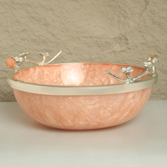 Copper bowl with silver decorative elements on a neutral background
