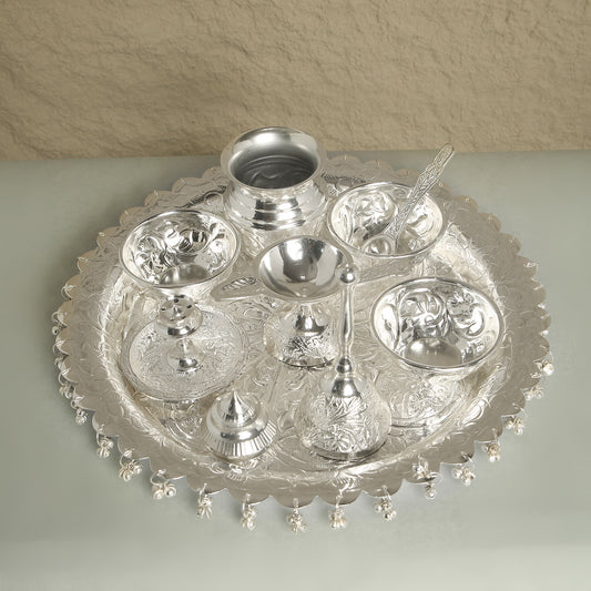 Silver platter with decorative items on a beige background