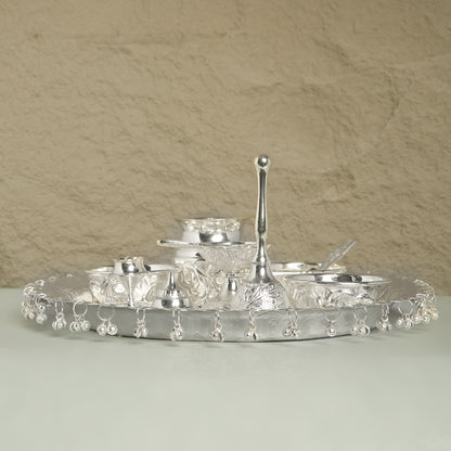 Silver tray with decorative elements on a beige background