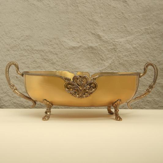 Decorative gold bowl with intricate designs on a beige background