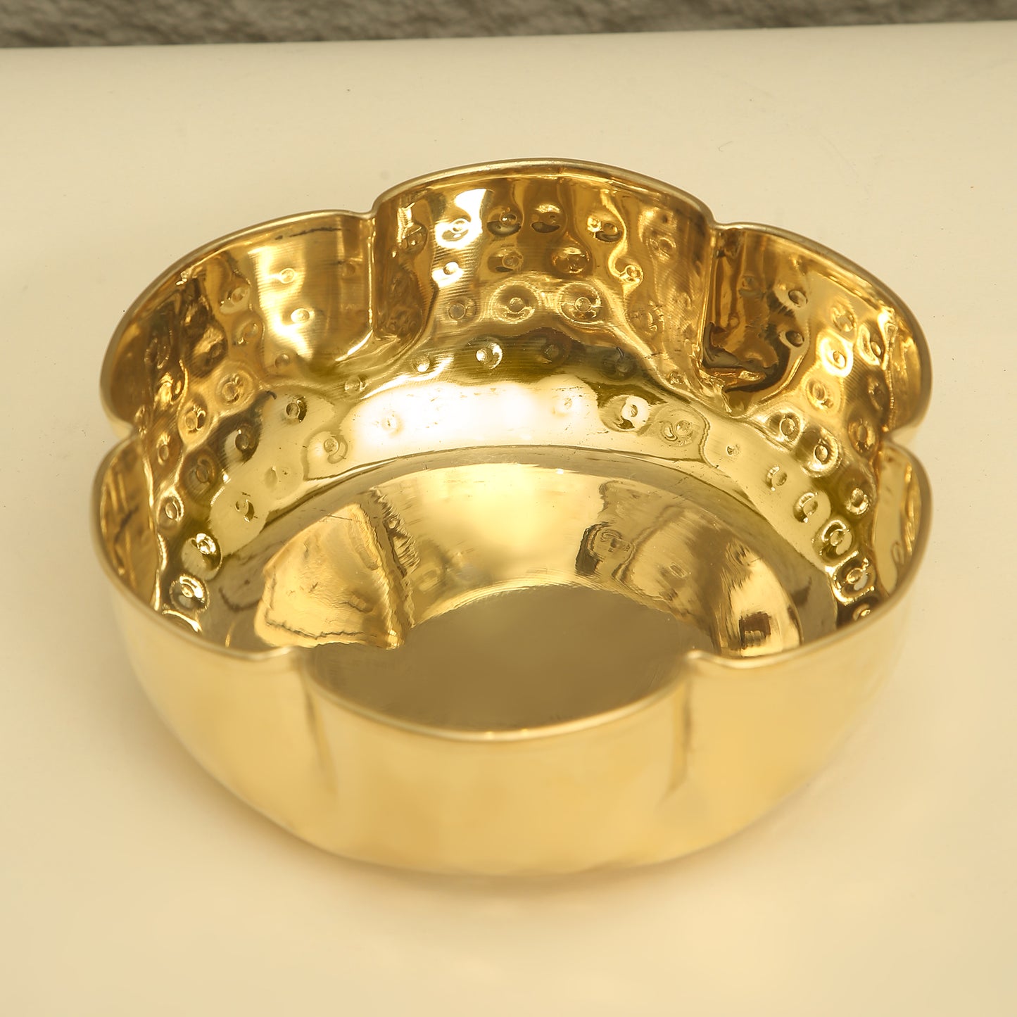 Gold ring with textured design on a white background