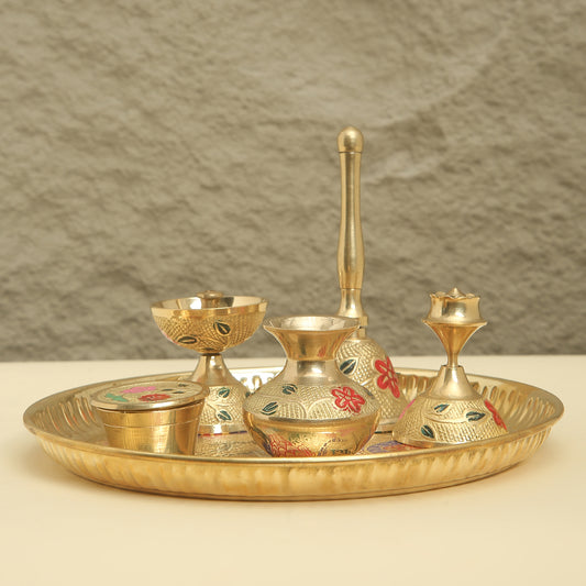 Gold-colored ceremonial set with tray, bowls, and candle holders on a neutral background