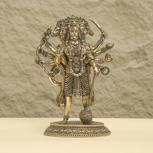 Bronze statue of a deity with multiple arms on a beige background