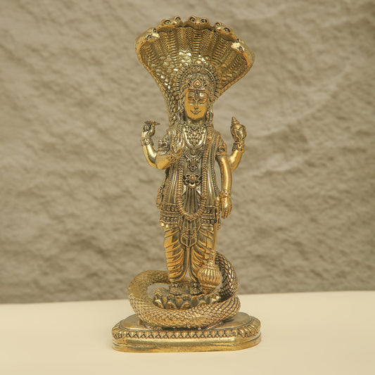 Decorative statue of a deity with intricate details on a neutral background