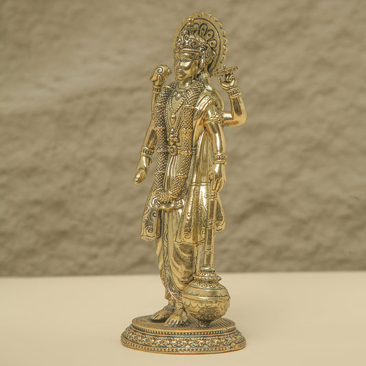 Gold-colored statue of a deity on a beige background