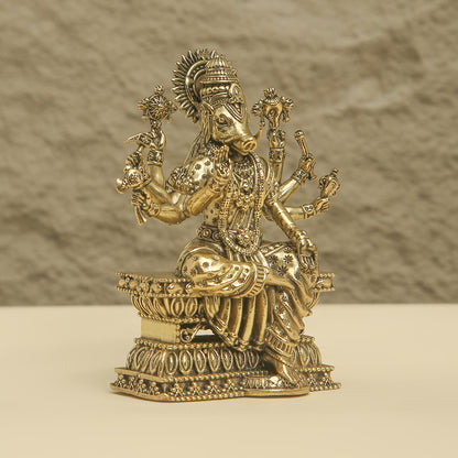 Decorative gold statue on a beige background
