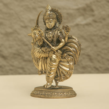 Bronze statue of a deity riding a goat on a beige background