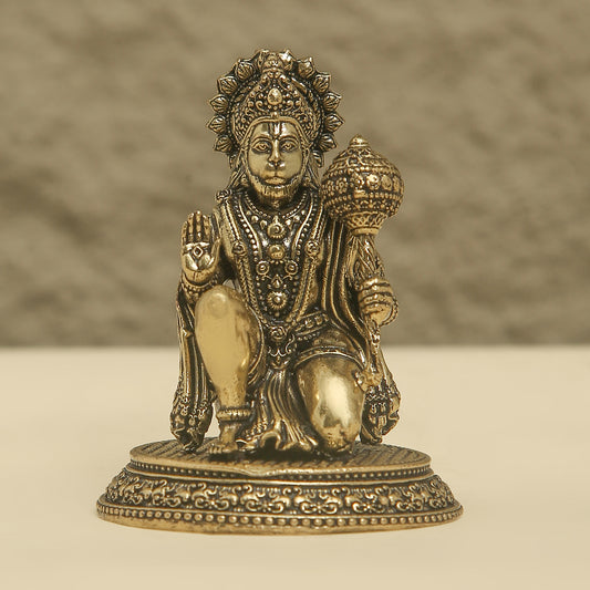 Bronze statue of a deity on a beige background