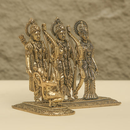 Bronze figurine of three deities on a plain background