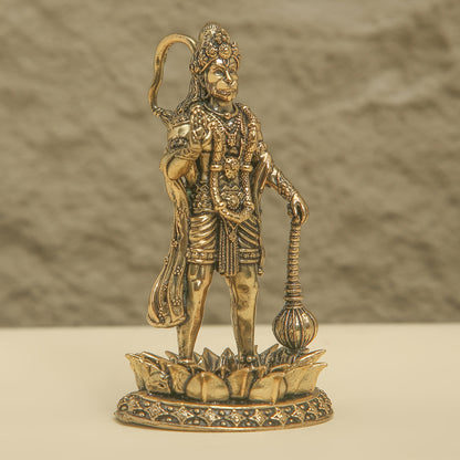 Bronze statue of a deity on a textured surface