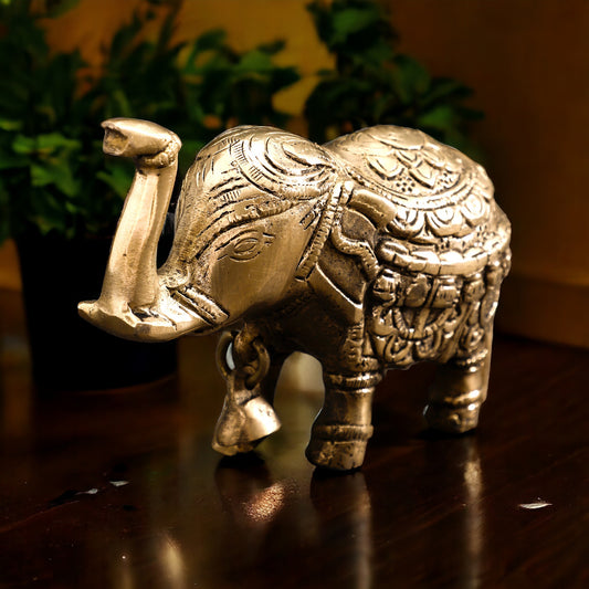 Decorative elephant figurine with intricate patterns on a wooden surface.