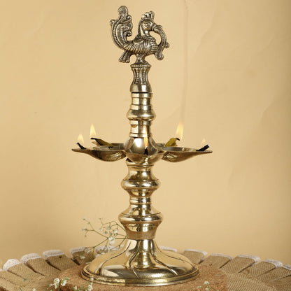 Brass lamp with decorative design on a beige background