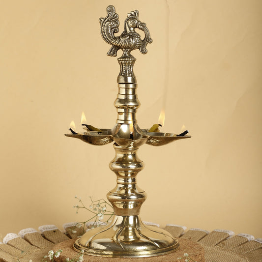Brass lamp with decorative design on a beige background