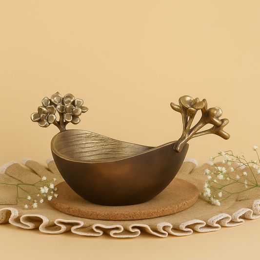 Decorative bronze bowl with floral designs on a beige background