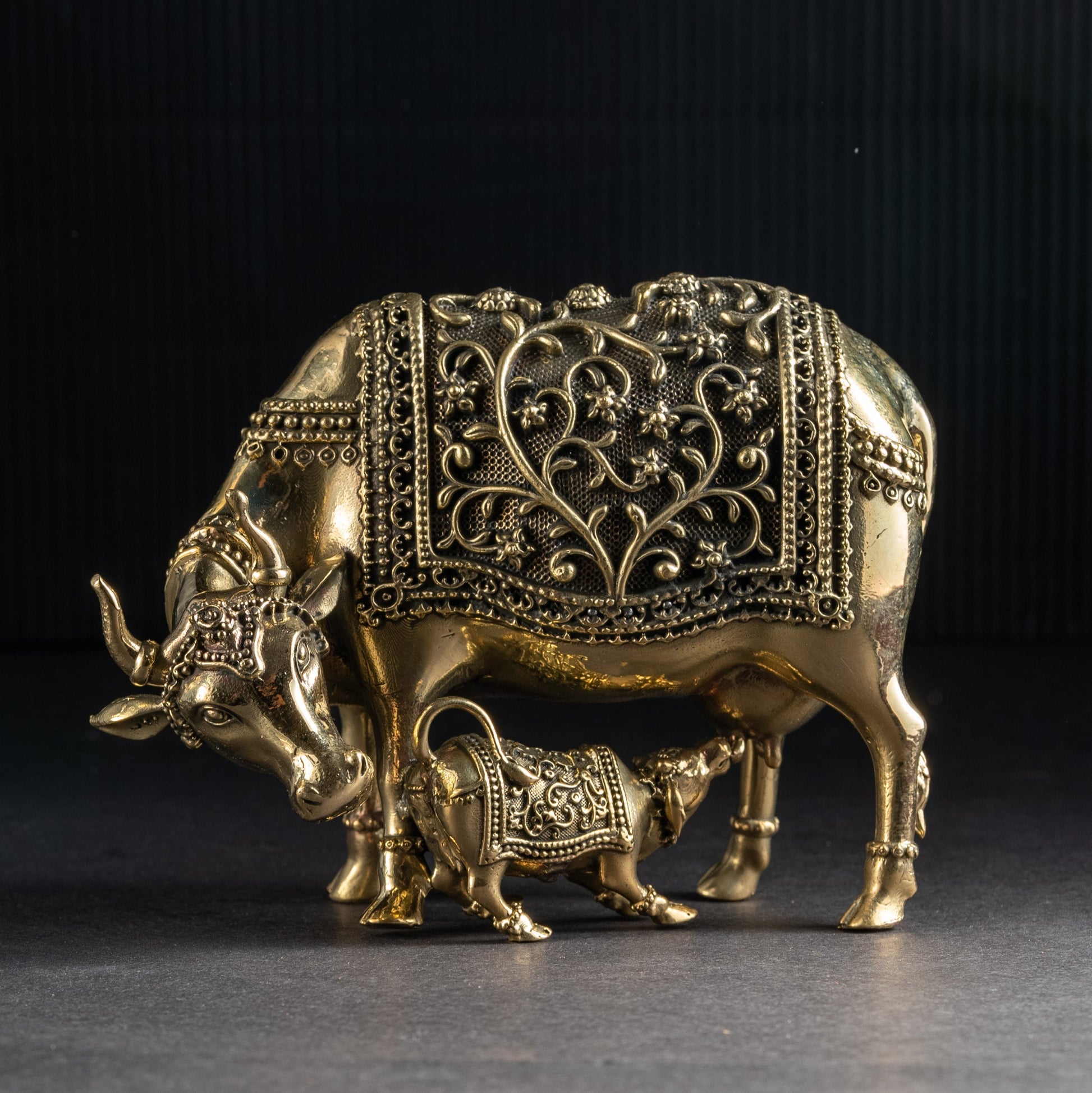 Decorative brass bull figurine on a dark background
