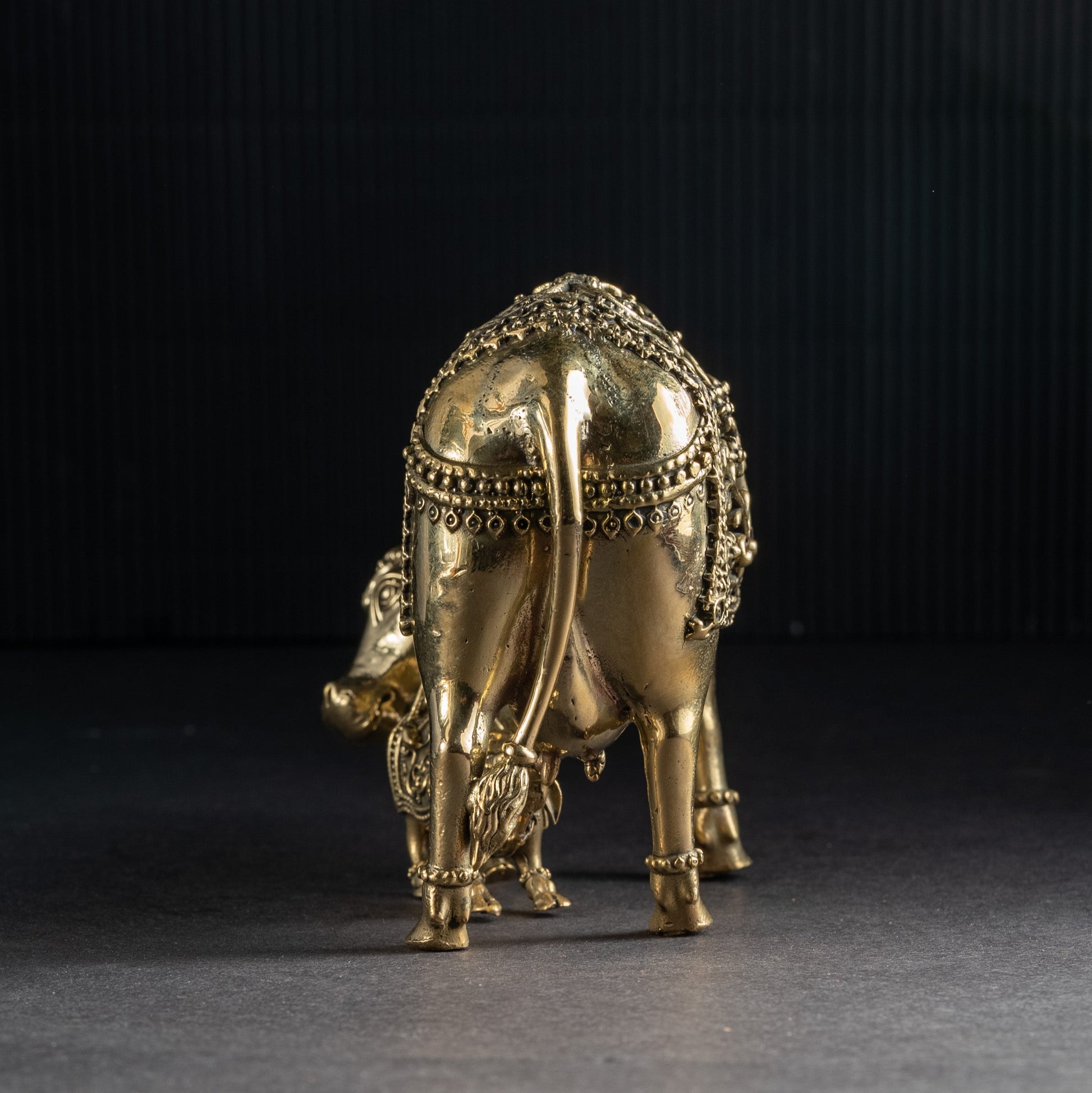 Gold elephant figurine on a dark background