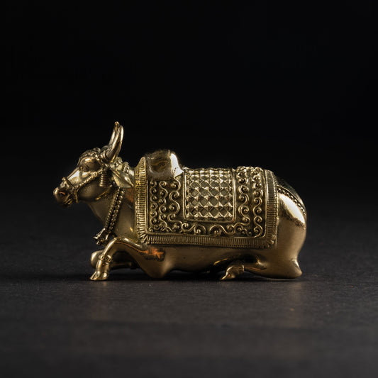 Gold bull figurine with intricate patterns on a black background