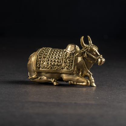 Bronze bull figurine on a black background