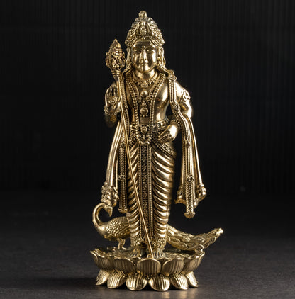Gold-colored statue of a deity on a black background