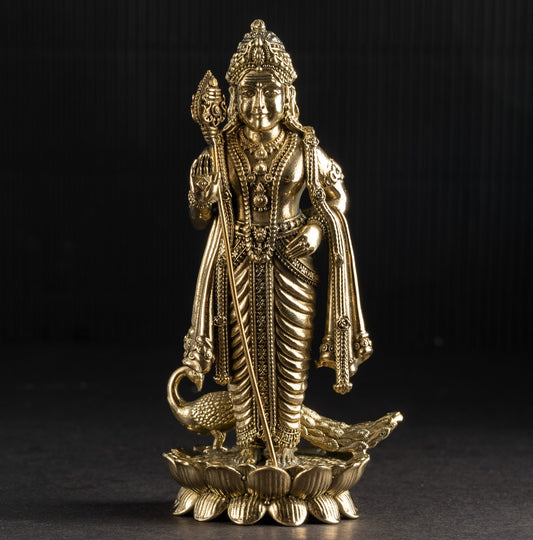 Gold-colored statue of a deity on a black background