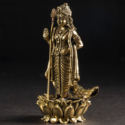Gold-colored statue of a deity on a dark background