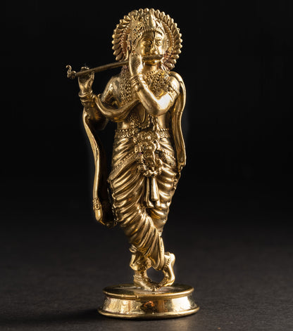 Gold statue of a deity on a black background